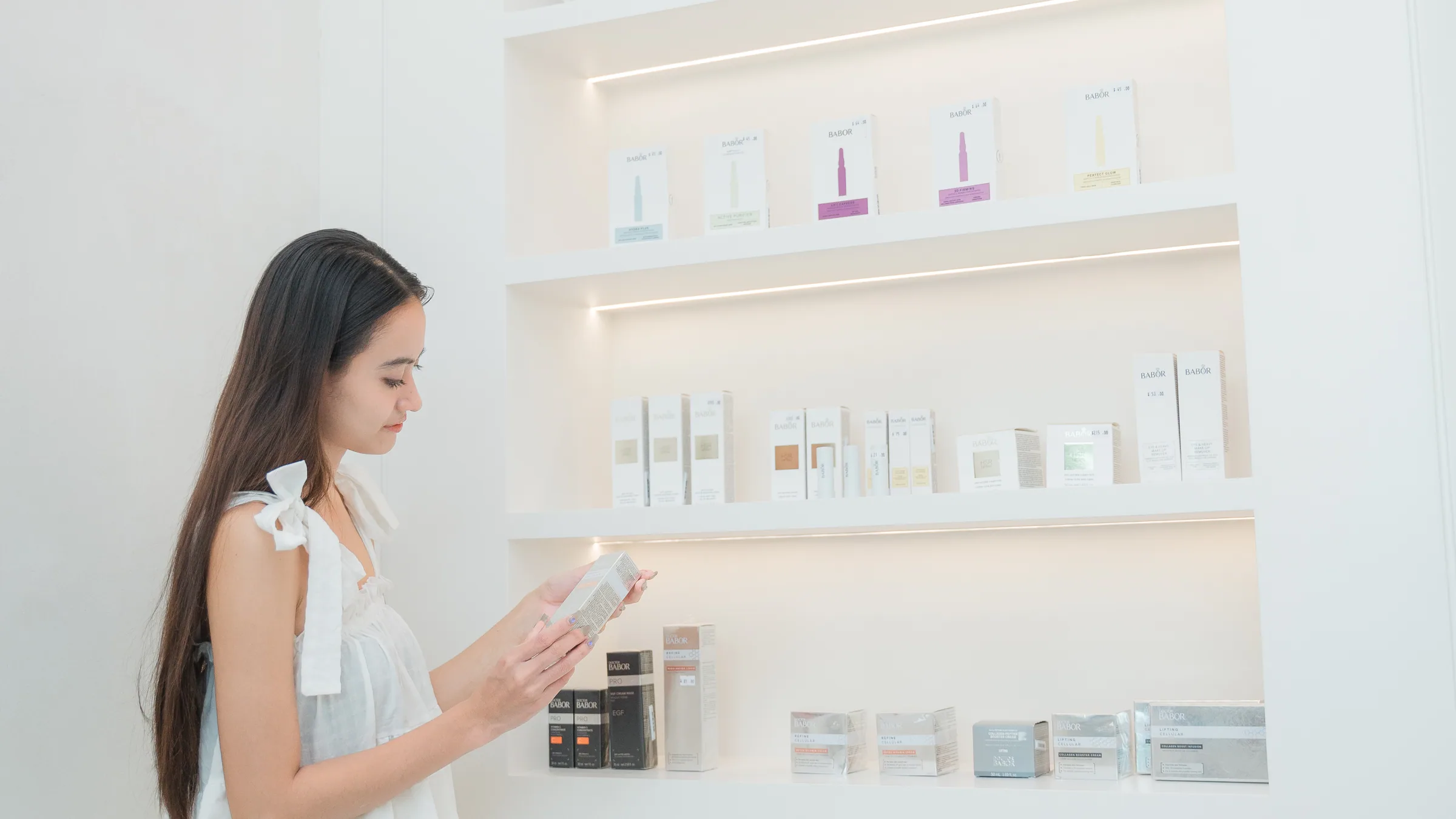 Client exploring BABOR skincare products at PG Aesthetic Center